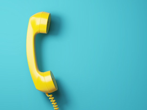 Vintage yellow telephone on aquamarine background 3d