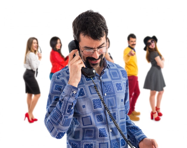 Vintage young man talking to vintage phone 