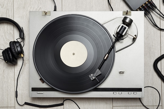 Photo vinyl player with long play or lp record and old-fashion headphones. top view.