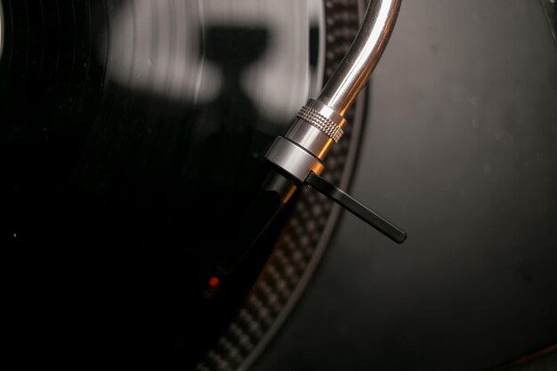 Vinyl record player closeup needle on vinyl record vintage\
concept black vinyl record