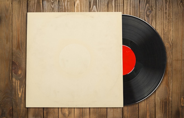 Vinyl record with the blank cover on wooden desk