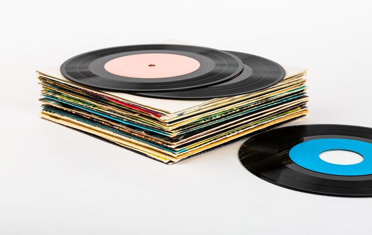 Vinyl records in a stack on a white background