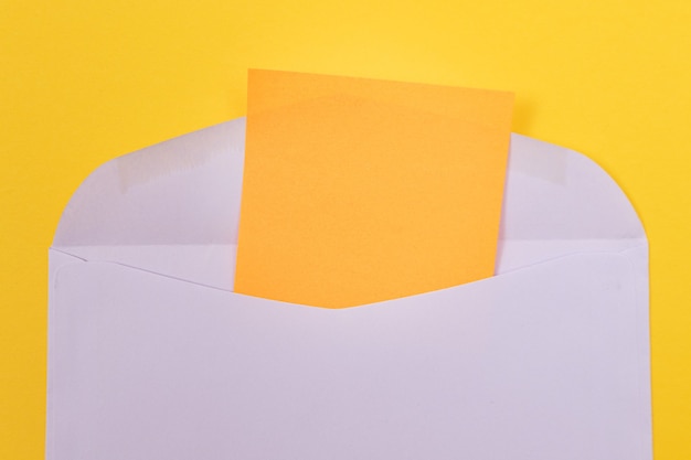 Violet envelope with blank orange sheet of paper inside