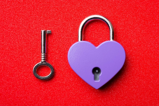 Violet heart and key on red background