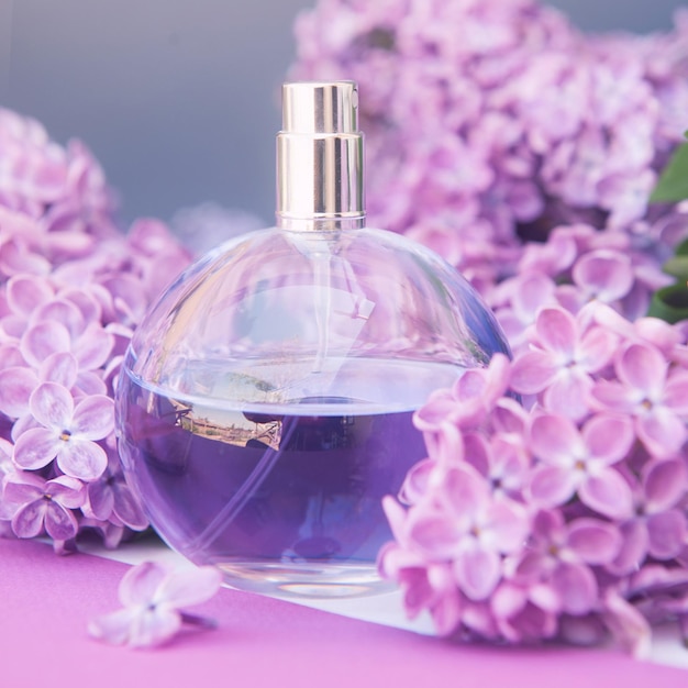 Violet perfume bottle with lilac flowers