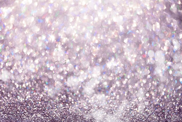 Photo violet and purple abstract bokeh lights. shiny glitter background with copy space. new year and christmas concept. sparkling greeting card