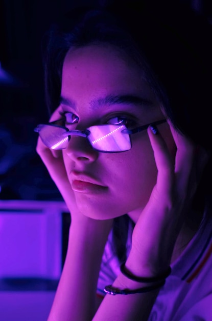 The violet reflection on her glasses