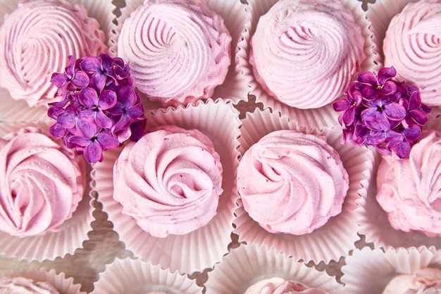 Violet sweet homemade marshmallow from blackcurrant near lilac flowers