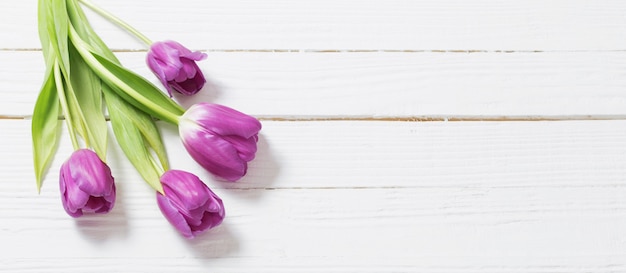 Violet tulpen op witte houten tafel