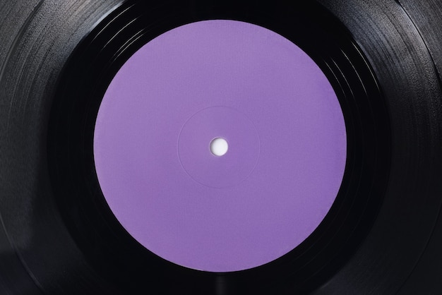 Violette blank label of LP vinyl record. Close-up shot, top view.