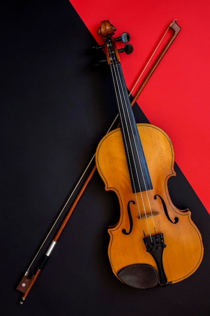 Violin and bow on a red and black background