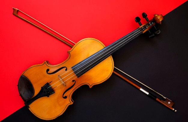 Violin and bow on a red and black background