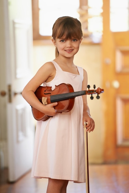 Violin girl and portrait of happy kid in home for learning practice and music education Art fiddle and student with bow for talent creative or hobby with acoustic string instrument in Canada