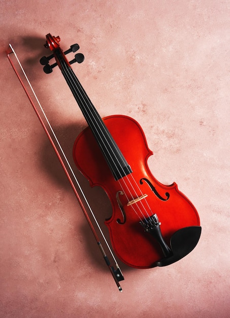 Violin on pink background studio shot