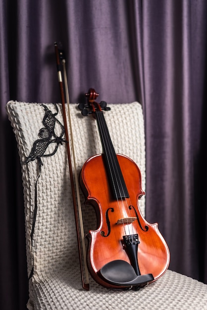 Violin with bow on empty chair