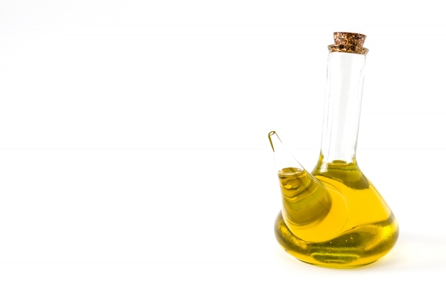 Virgin olive oil in a crystal bottle isolated on white