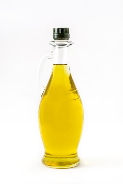 Virgin olive oil in a crystal bottle isolated on white