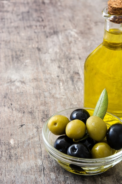 Virgin olive oil in a crystal bottle on wooden table