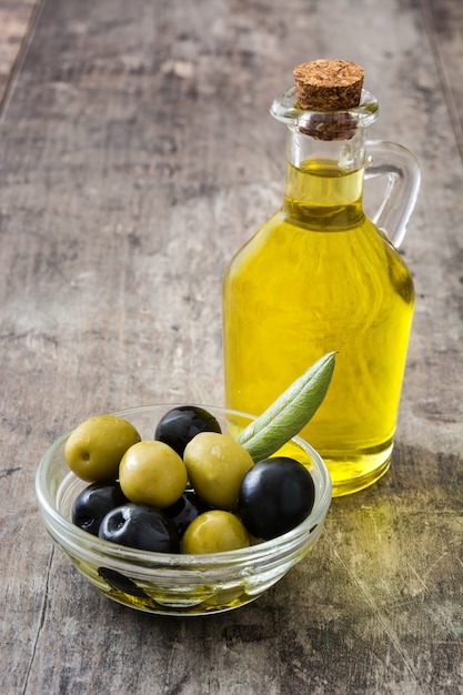 Virgin olive oil in a crystal bottle on wooden table