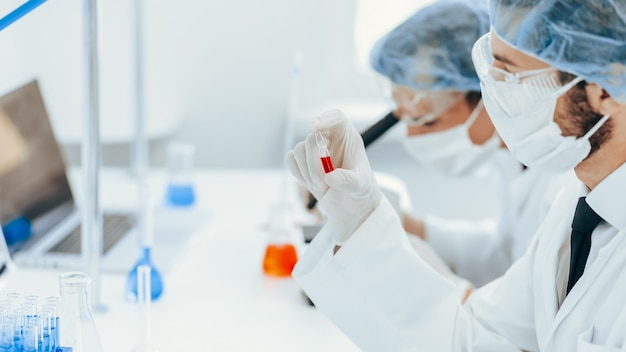 virologist holds an ampoule with a new vaccine