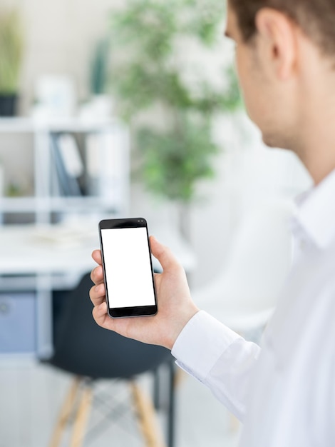 Virtual conference digital mockup office work unrecognizable man holding smartphone with blank