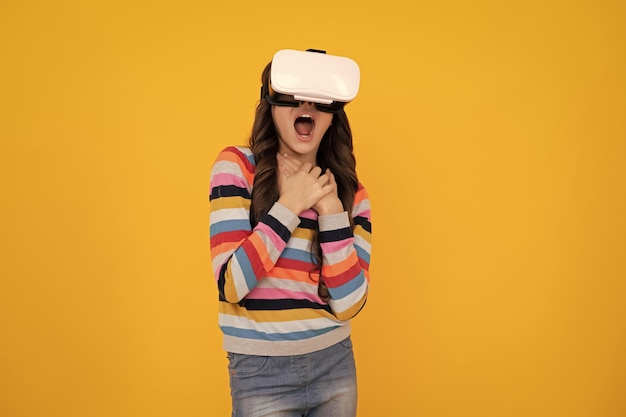 Virtual gadgets for child free time and study teen school girl uses vr glasses isolated on yellow