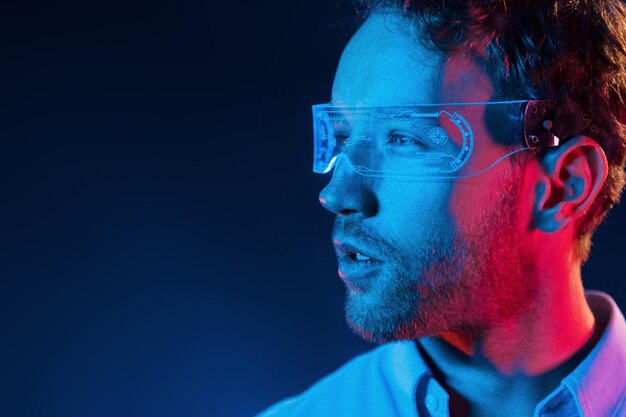 virtual reality concept neon lighting young european man is in the dark studio