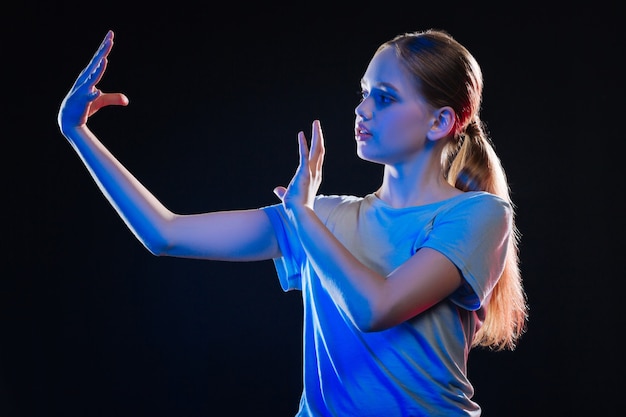 Virtual reality concept. Nice serious woman moving her hands while using virtual technological device