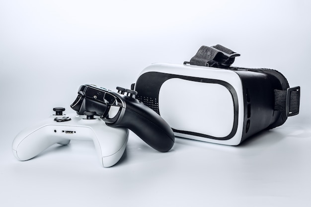 Virtual Reality glasses and game pad Isolated on white.