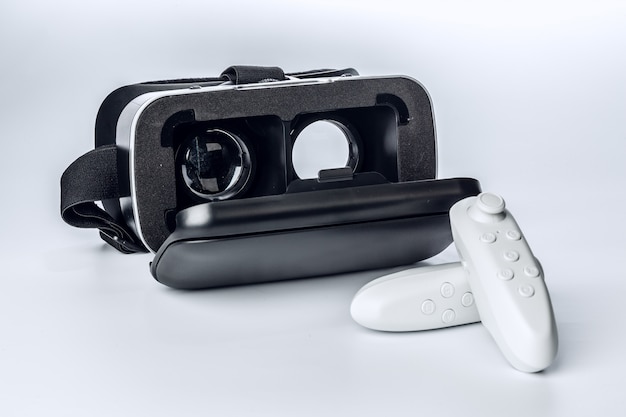 Virtual Reality glasses and game pad isolated.