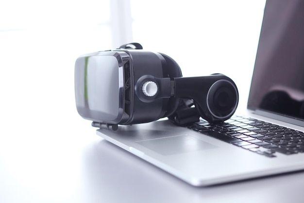 Virtual reality goggles on desk with laptop business 3d technology