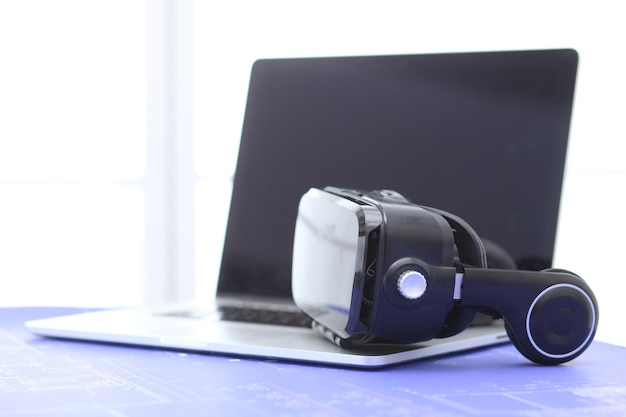 Virtual reality goggles on desk with laptop business 3d technology