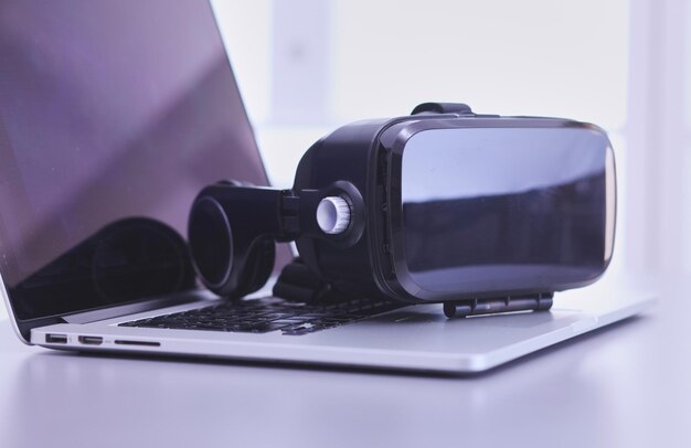 Virtual reality goggles on desk with laptop business 3d technology