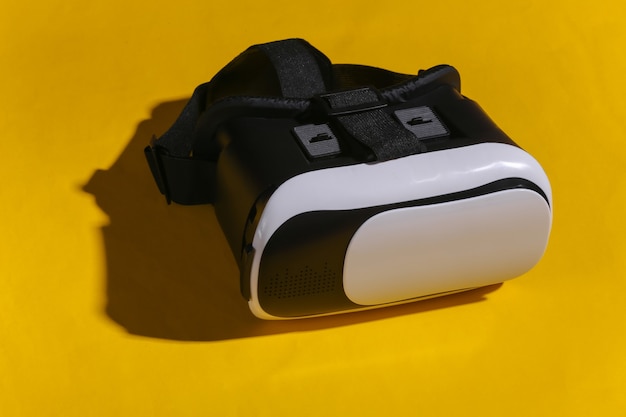 Virtual reality headset with joystick on yellow background. Modern gadgets