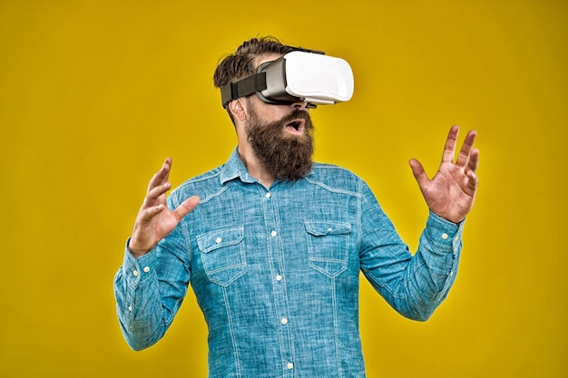 Virtual reality is truly here bearded man wear virtual reality headset hipster explore virtual reality yellow background virtual reality technology and future vr communication video training