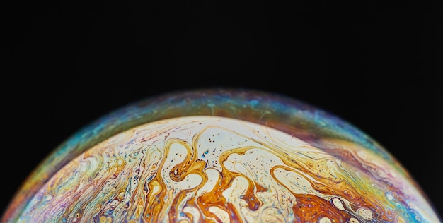 Virtual reality space with abstract multicolor psychedelic\
planet closeup soap bubble like an alien planet on black\
background