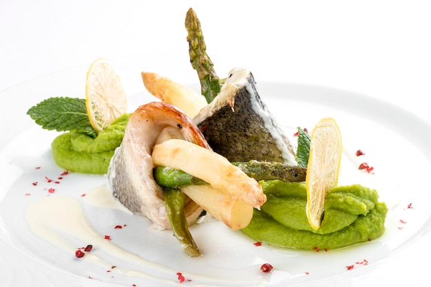 Visfilet met asperges op een witte achtergrond