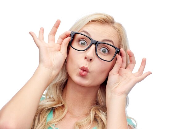 vision, education and people concept - happy young woman or teenage girl glasses making funny fish face