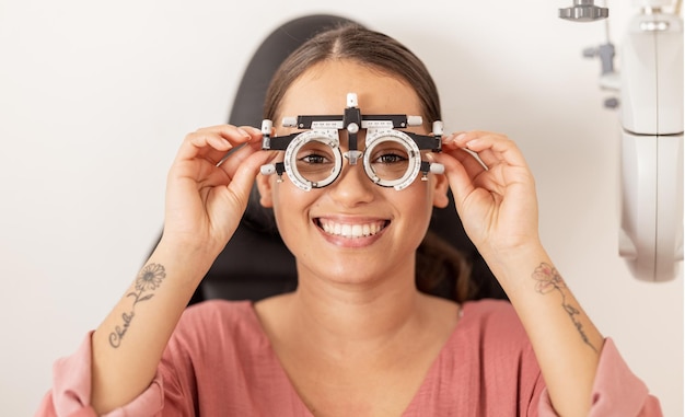 Vision healthcare and eyes test for a woman with glasses checking optical wellness with a smile on her face Insurance and happy customer testing retina for eye care exam at trusted optometry clinic