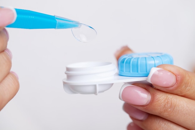 Vision problems close up of woman holding container with contact lenses