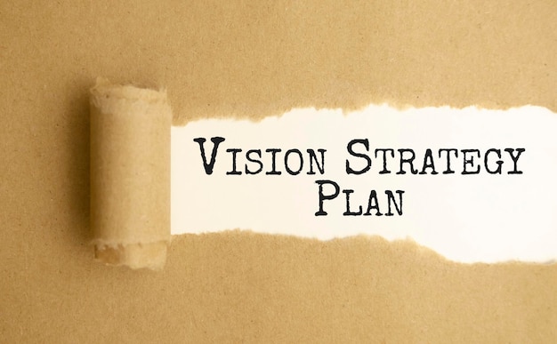 Photo vision strategy plan words written under torn paper