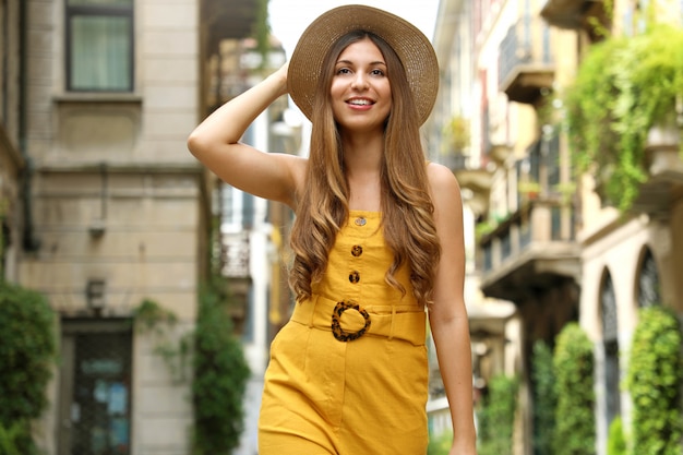 Visit Milan. Young fashion woman walking in city street of Brera neighborhood in Milan, Italy.