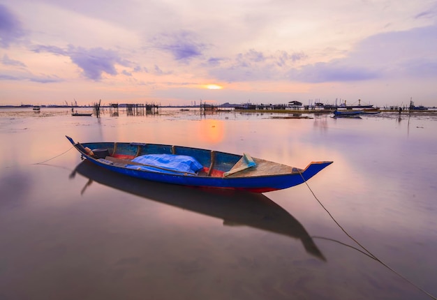 vissersboot bij zonsondergang in het dorp traditionele boot