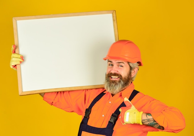 Visual outline troubleshoot concept bearded man repairman\
builder plan repair works repairman hold whiteboard copy space\
handsome repairman architect showing project professional\
repairman