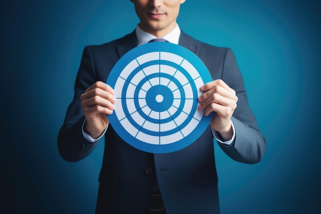 Visualize success with an image of a businessman confidently holding a large dart board that represe