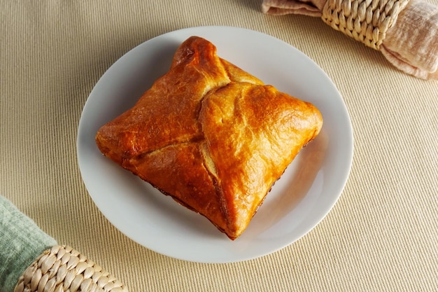 A visually stunning composition featuring a perfectly baked puff pastry adorning a pristine white plate