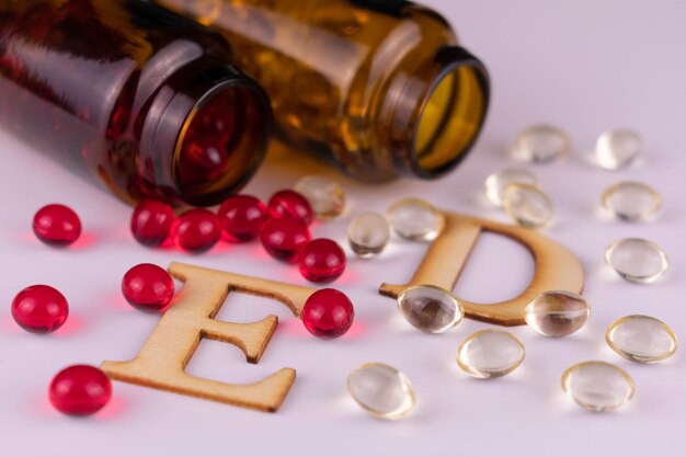 Vitamin E and Vitamin D capsules Closeup