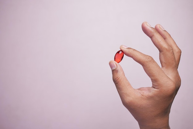 Vitamin hair capsule oil on hand