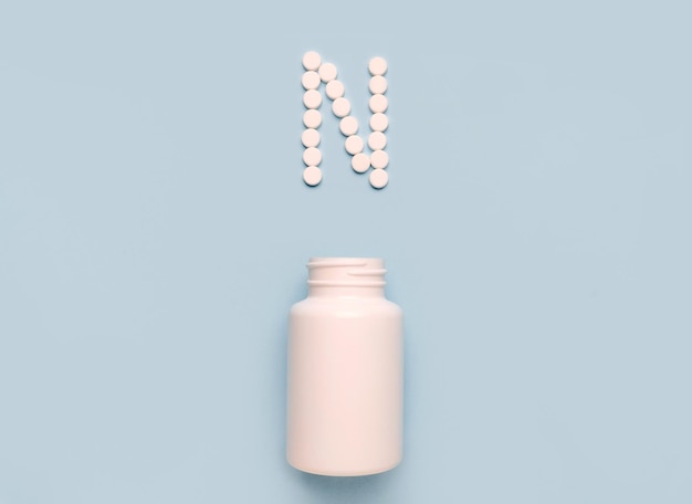 Vitamin N biotin icon from tablets and drug bottle on blue background Colltction of vitamin and minerals