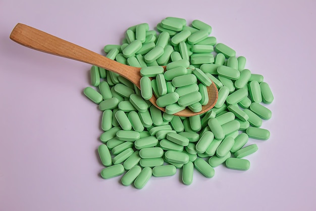 Vitamin tablets used as a dietary supplement.green\
tablets..selective focus.medical